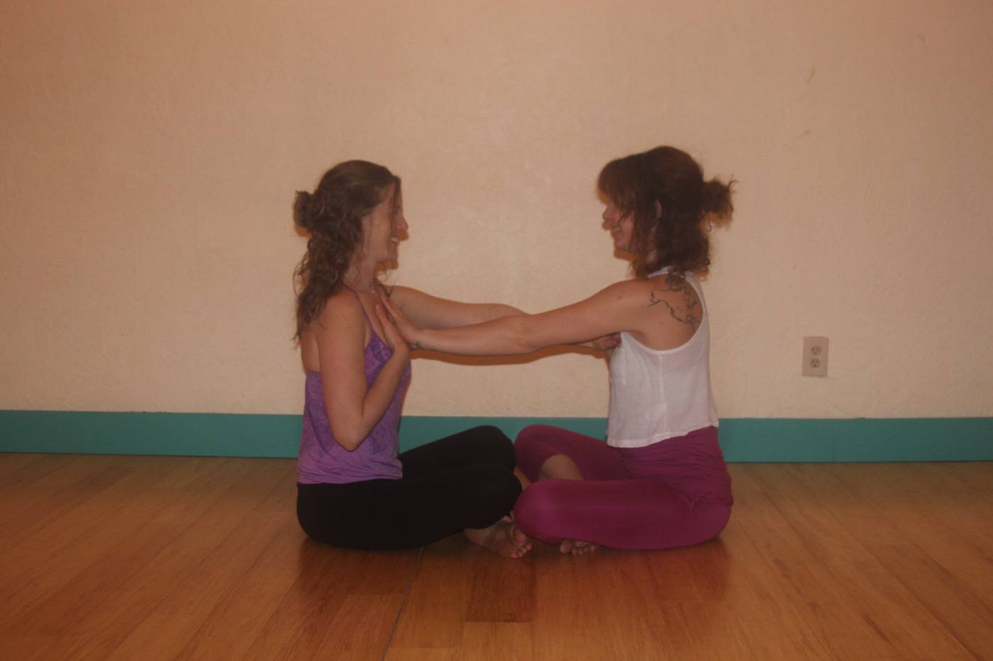 Premium Photo | Partner yoga side view of flexible women helping each other  practicing inversion balancing yoga pose handstand on mat