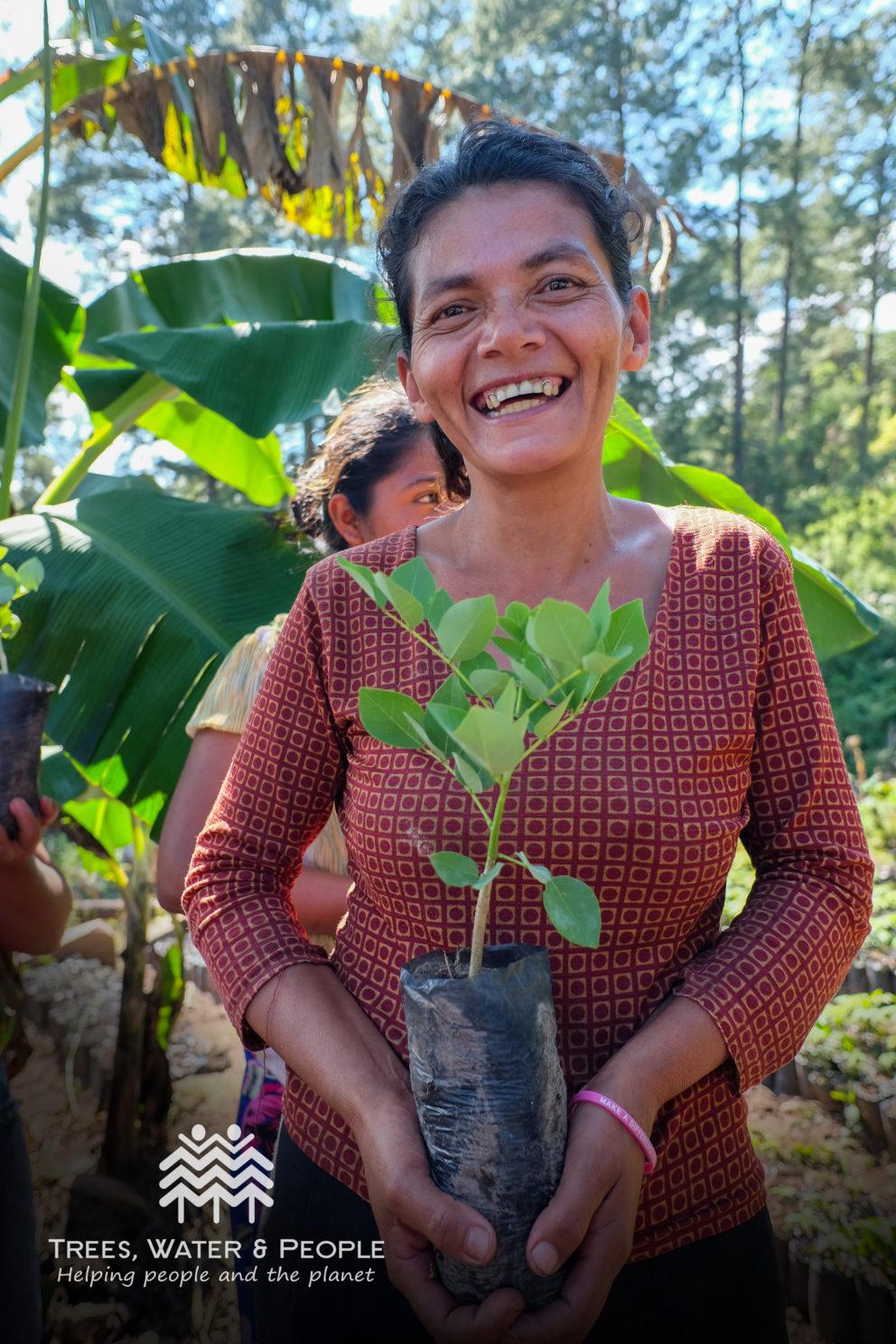 woman holding tree