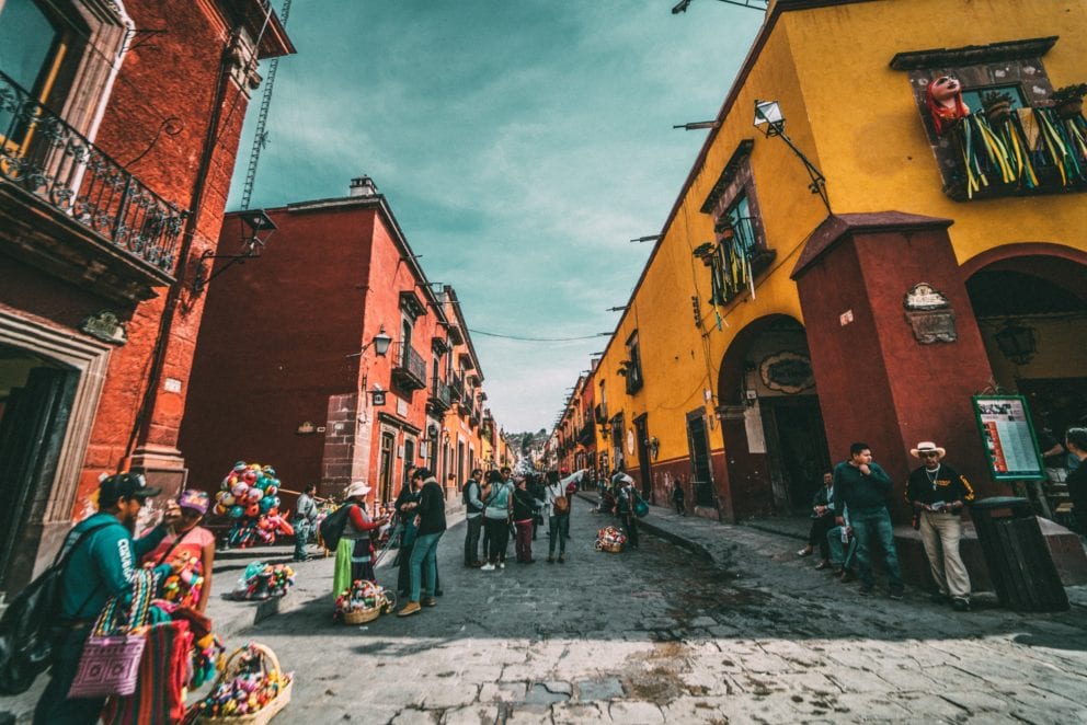 Mexican street with colorful buildings and artisans