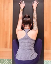 woman in child's pose on yoga mat libby nicholas