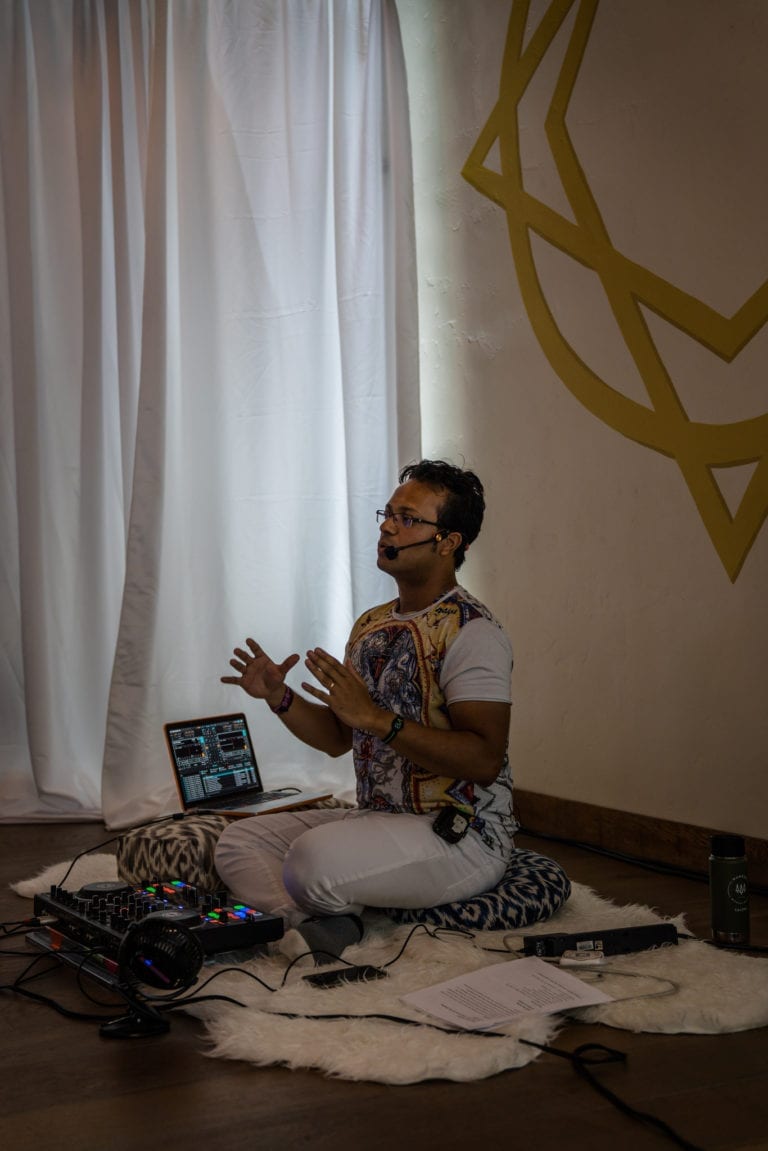 man sitting teaching with DJ equipment