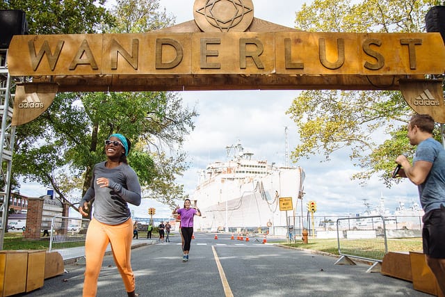 people running across Wanderlust finish line