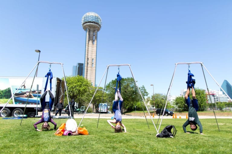 Three people practicing Aireal Yoga at the Dallas 108