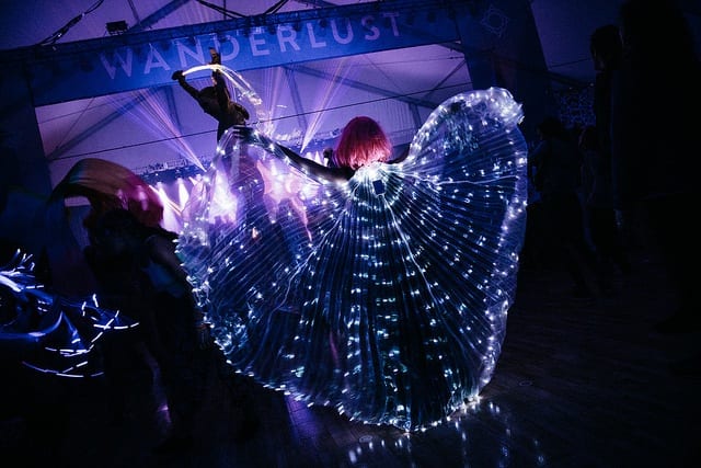 concert with purple lights and lit butterfly wings spread