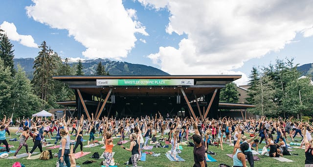 people doing yoga in whistler olympic plaza