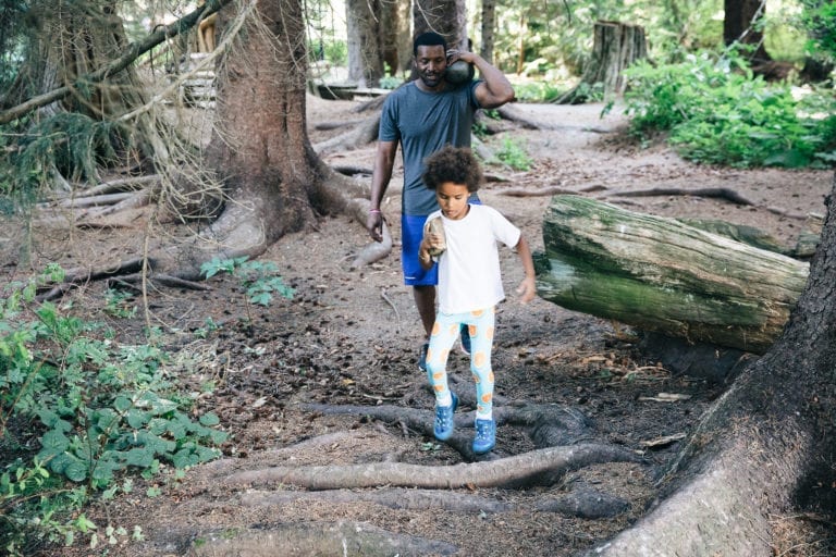 Father and son wandering through the forest. 