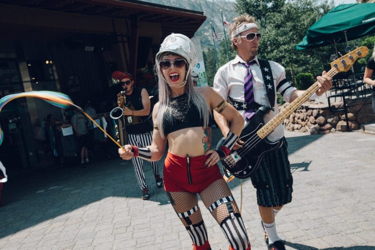 Fun musicians playing instruments on the streets of Alpine Village.