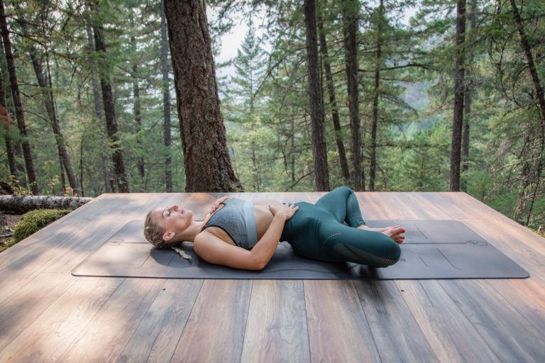 woman laying in supta baddhakonasana