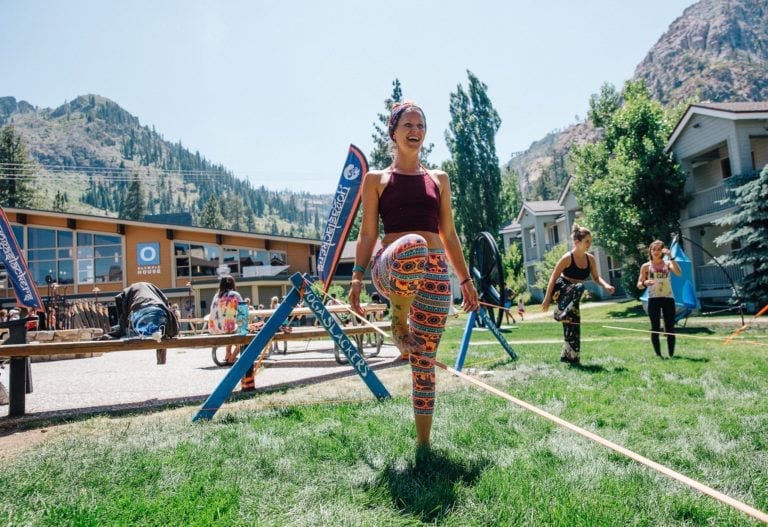 woman on slackline in mountain town