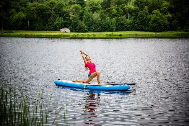 woman on SUP yoga board lake in Vermont