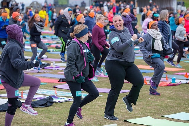 people dancing outside in field