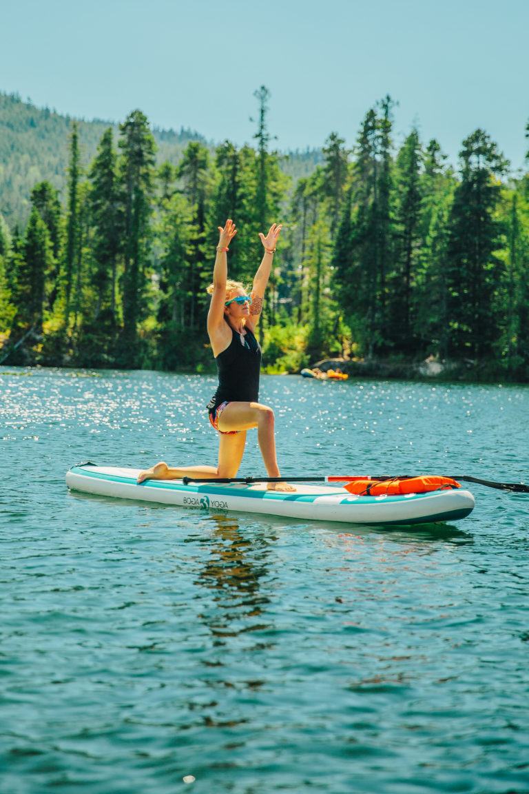 woman in low lunge on paddleboard in british columbia