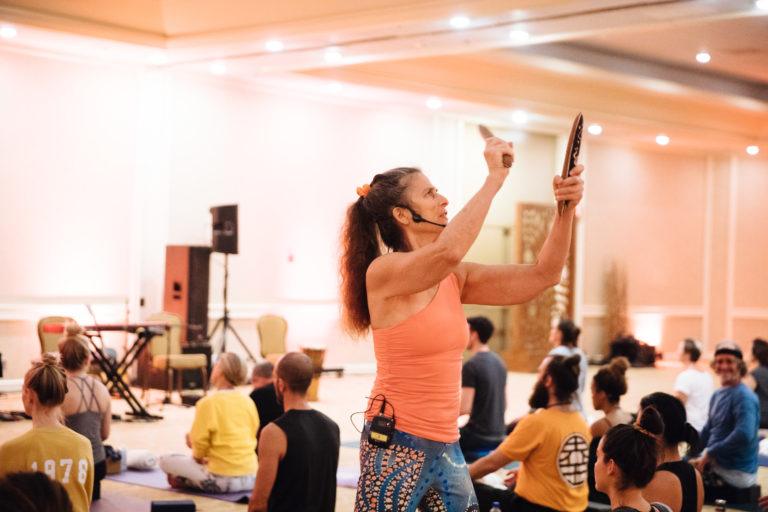 woman yoga teacher playing sticks