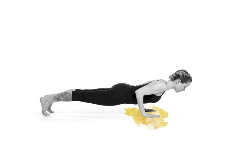 woman in chaturanga pose