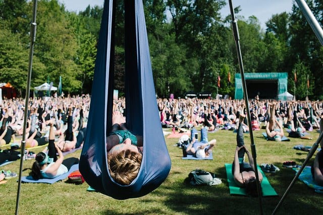 woman in aerial rig with yoga class