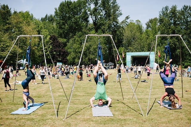 people in aerial rigs at large scale festival