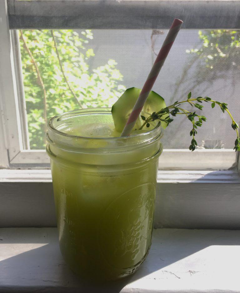 lime mocktail by window with sprig of thyme