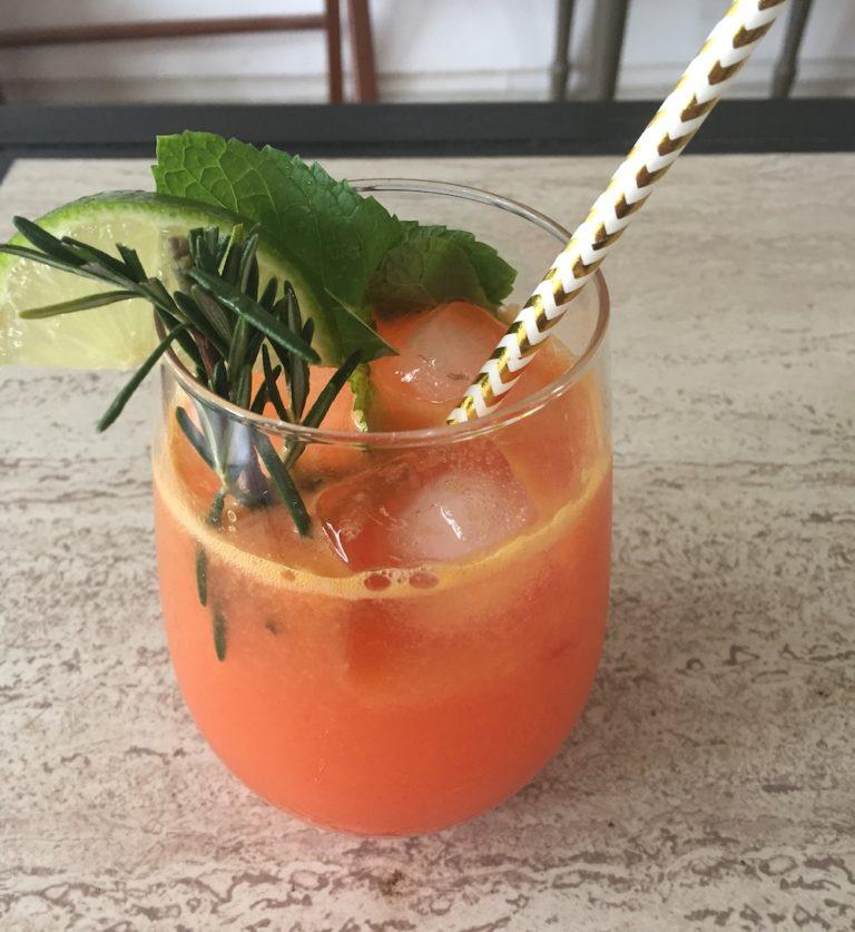 orange mocktail with rosemary and mint