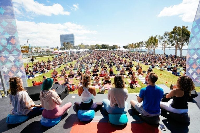 people teaching meditation on stage