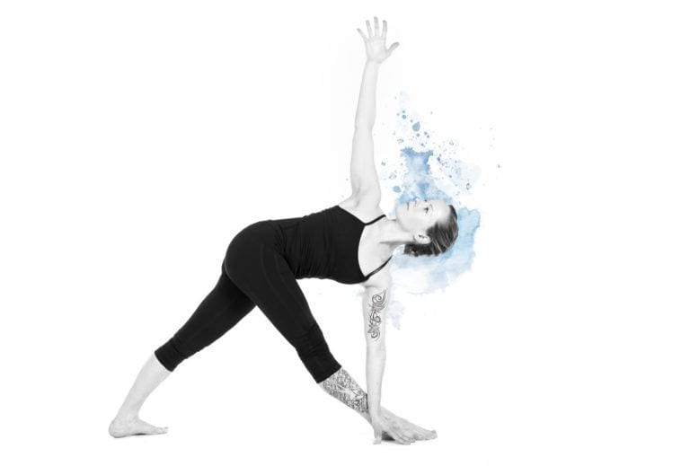 woman against white background in Triangle Pose