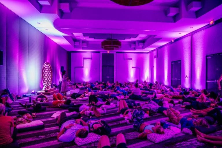 woman teaching sound journey in purple room