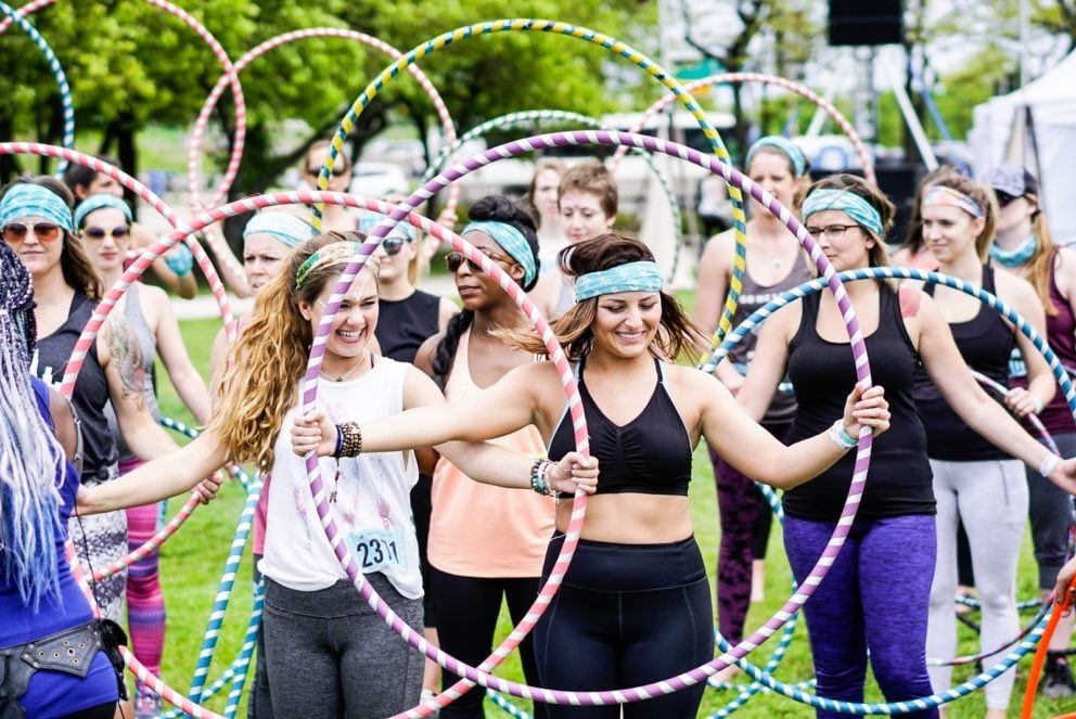 group of people with hula hoops