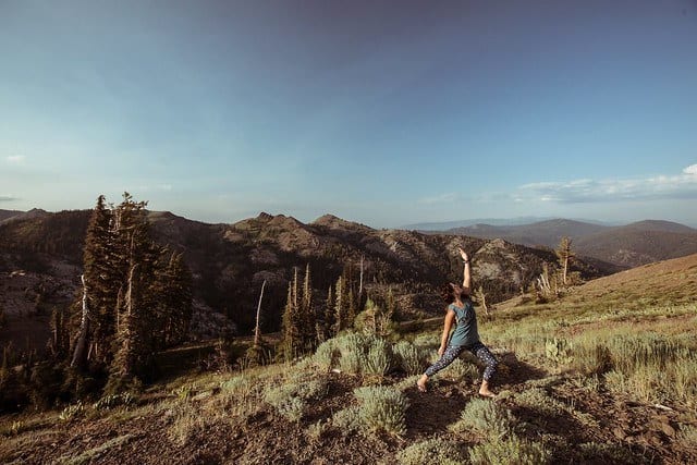 people doing yoga on mountain