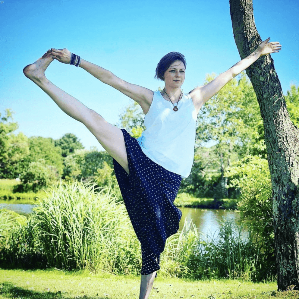 woman in yoga pose lake