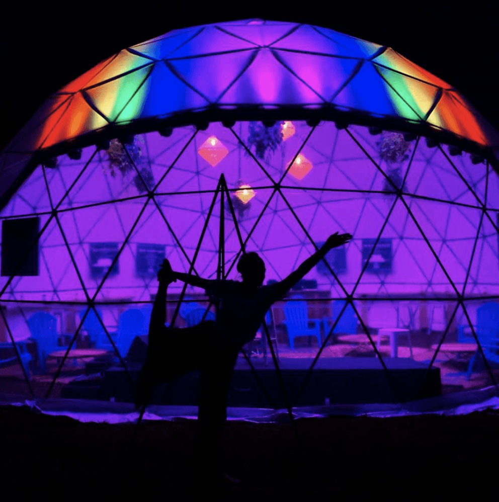 woman in dancers pose dome rainbow