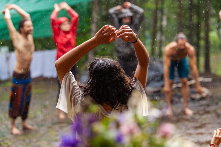 Diverse people enjoy spiritual gathering A multigenerational group of people are seen standing in a circle in a forest clearing, worshipping native cultures during a mindful congregation in nature.